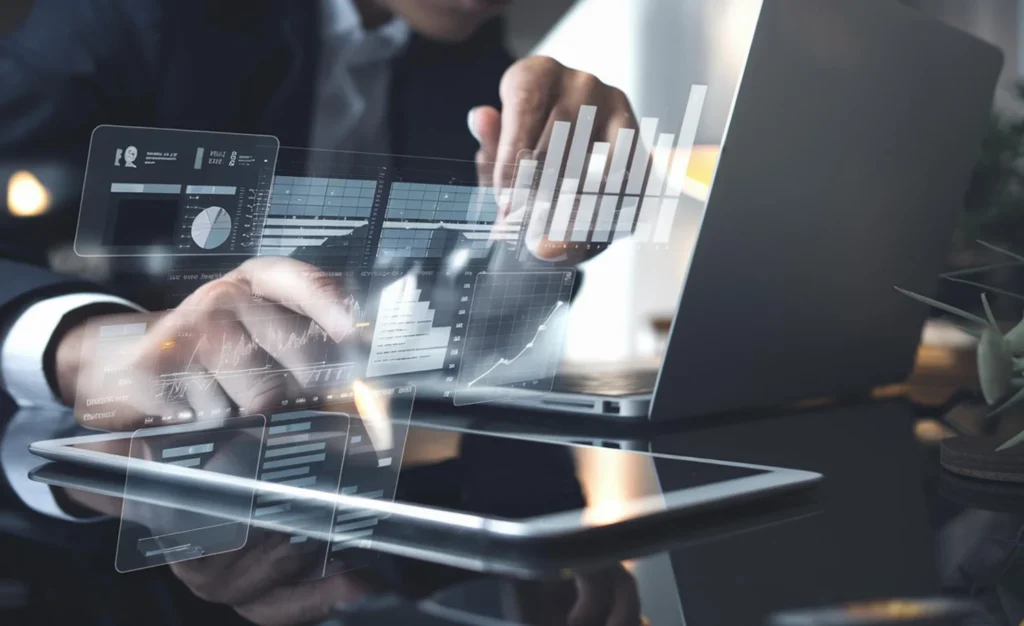 A business professional interacting with holographic data dashboards and analytics charts displayed above a laptop and tablet, representing AI-driven billing automation and real-time financial data management, AI-driven billing platform in USA.