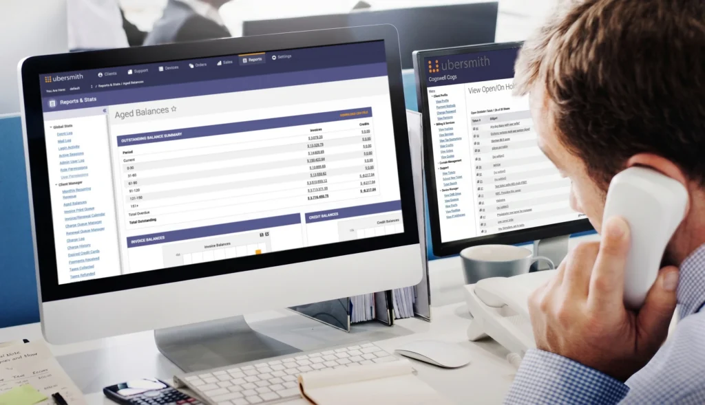 A cloud operations manager reviewing aged balances and open support tickets on the Ubersmith platform across two monitors, support ticketing and billing platform.